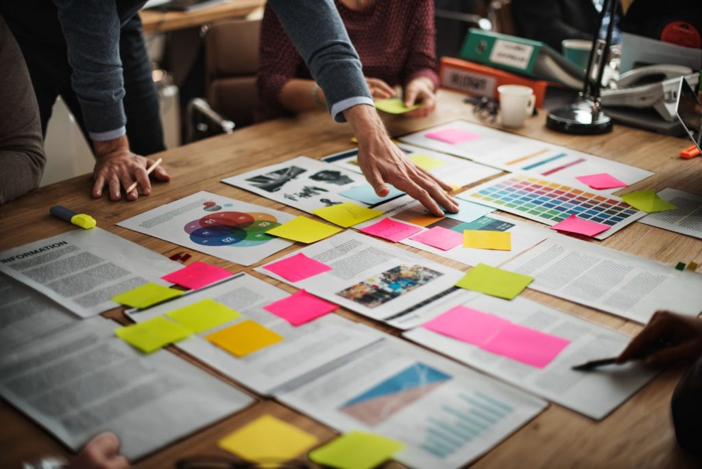 creative brainstorming session with colorful sticky notes and planning documents