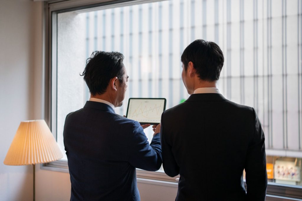 Two guys looking at graph